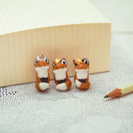 Nodding off fox with a star pendant