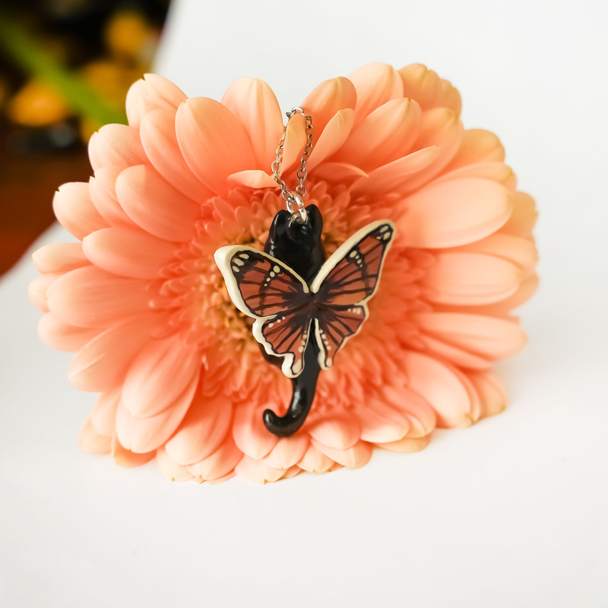 Black and white cat with butterfly wings pendant