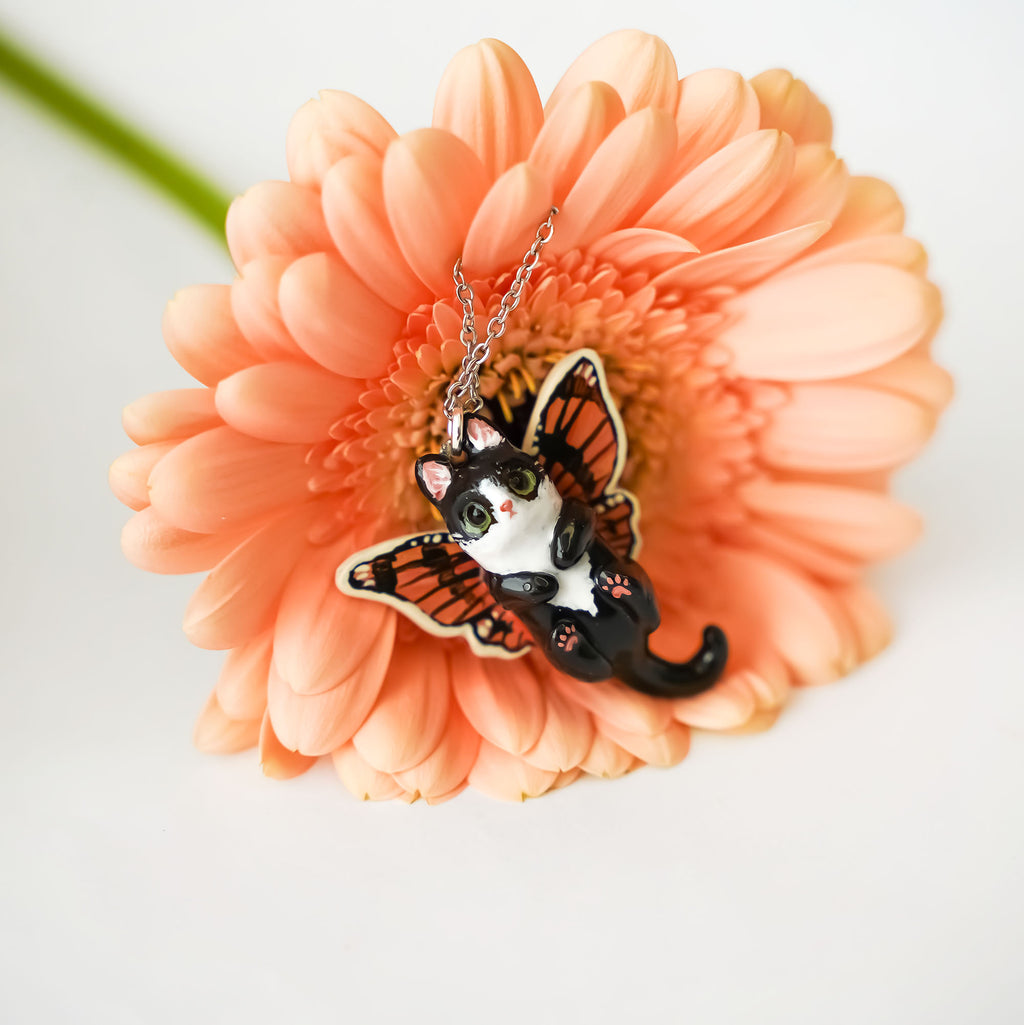 Black and white cat with butterfly wings pendant