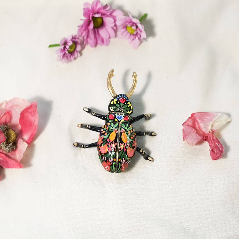 Black beetle with citrus and flowers