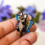 Black-footed cat with butterfly wings pendant