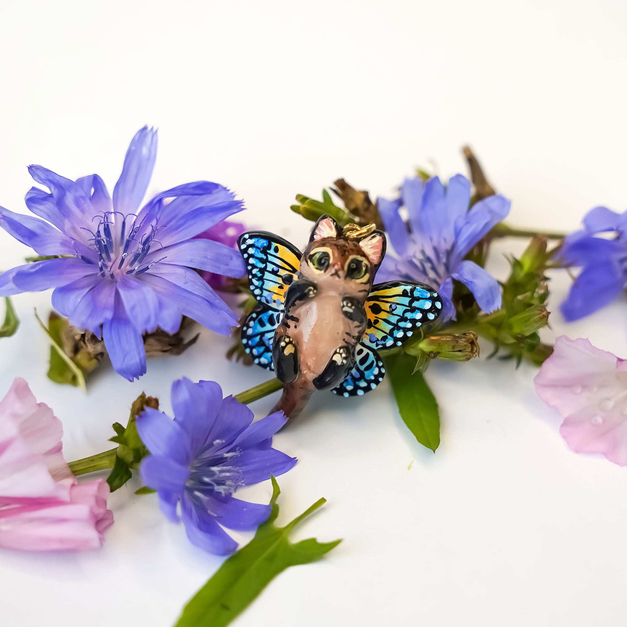 Black-footed cat with butterfly wings pendant