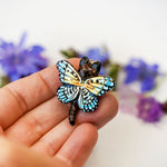 Black-footed cat with butterfly wings pendant