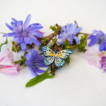 Black-footed cat with butterfly wings pendant