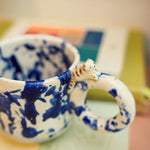 Ceramic cup with a porcelain cat