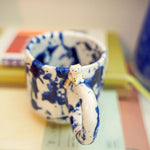 Ceramic cup with a porcelain cat