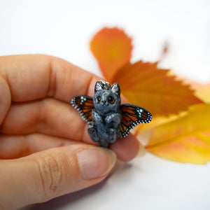 British shorthair cat with butterfly wings pendant