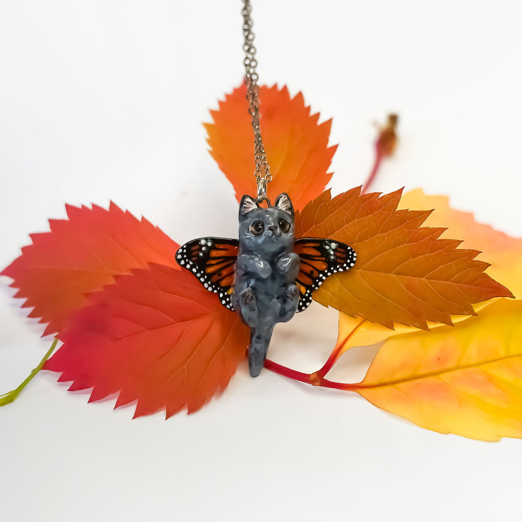 British shorthair cat with butterfly wings pendant