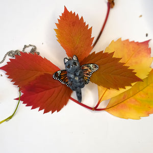 British shorthair cat with butterfly wings pendant