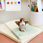 Calico cat with butterfly wings and strawberry sweater