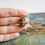 Tabby cat with a lace pendant