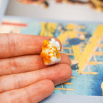 Maneki neko with a flower pendant
