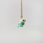Budgie with fruit pendant