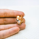 Happy Corgi with a star pendant