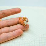 Happy Corgi with a star pendant