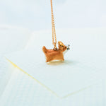 Happy Corgi with a star pendant