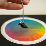 Crow with a silver moon pendant