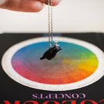Crow with a silver moon pendant
