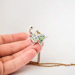 Dinosaur with flowers pendant