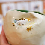 Ceramic flower pot with a stegosaurus