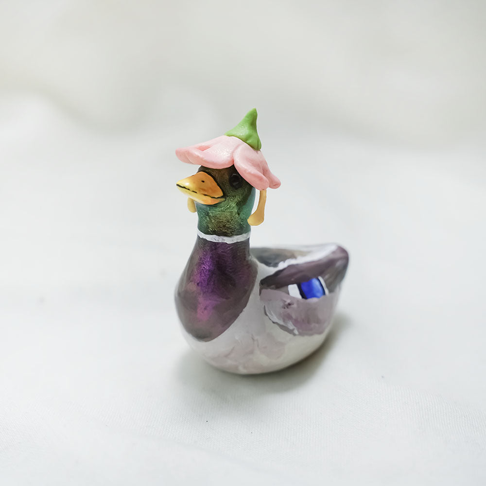 Duck with hats (frog and flowers) figurine
