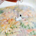 Ermine with a silver star pendant