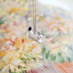 Ermine with a silver star pendant