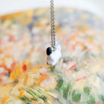 Ermine with a silver star pendant