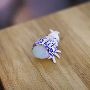 Firefly with blue flowers and an opalite