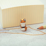 Sitting fox with a star pendant