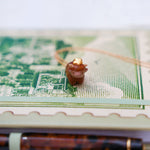 Highland cow with a gold star pendant