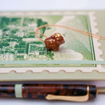 Highland cow with a gold star pendant