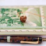 Highland cow with a gold star pendant