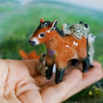 Przewalski horse with baby snow leopards figurine