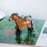 Przewalski horse with baby snow leopards figurine