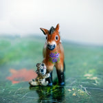Przewalski horse with baby snow leopards figurine