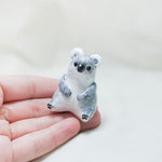 Koala with hats (pig and octopus) figurine