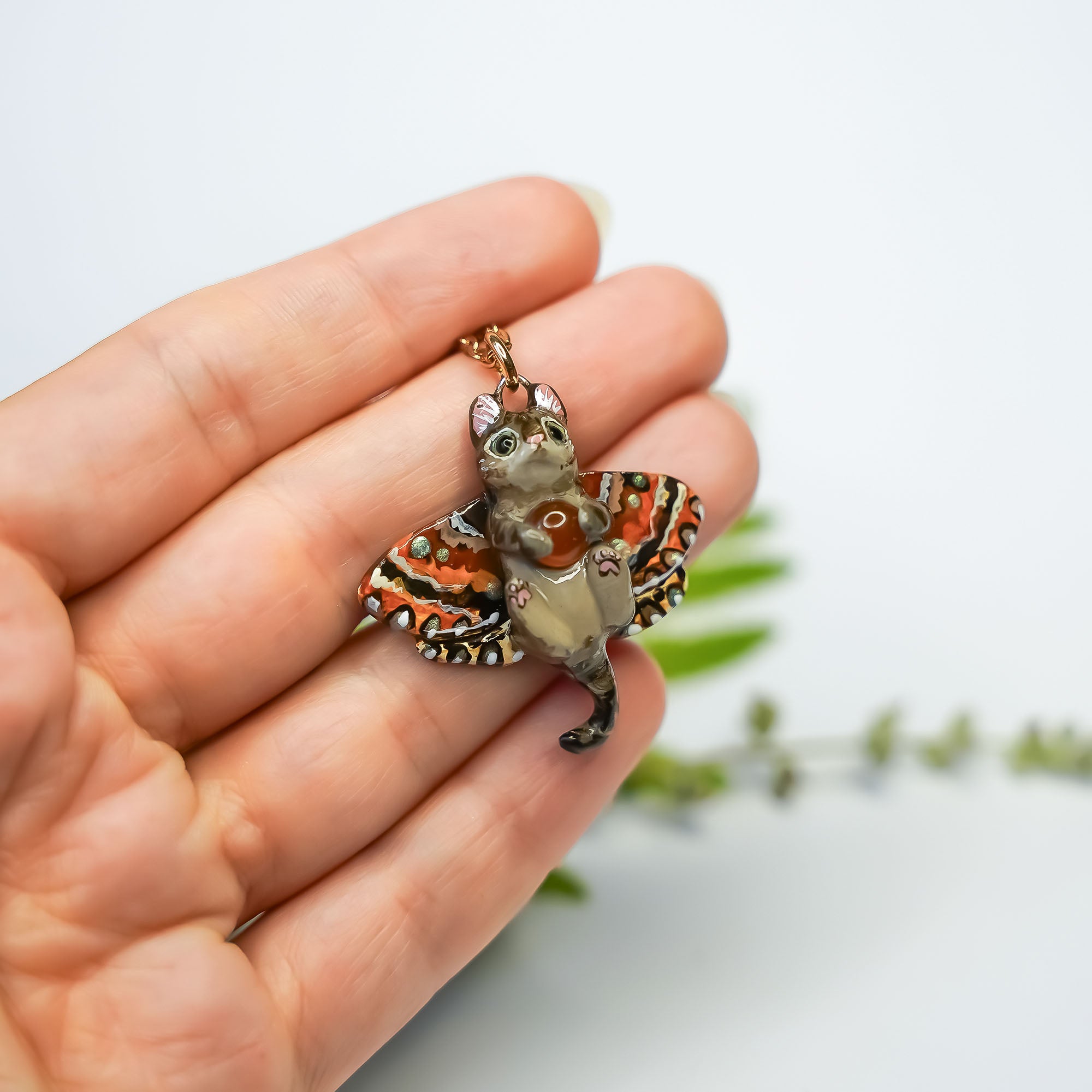 Tabby cat with a carnelian and wings pendant