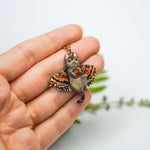 Tabby cat with a carnelian and wings pendant