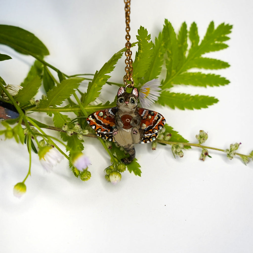 Tabby cat with a carnelian and wings pendant