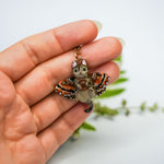 Tabby cat with a carnelian and wings pendant
