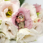 Tawny owl with a pink bow