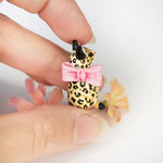 Leopard with a pink bow