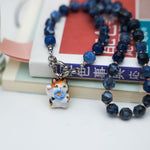 Maneki neko calico with a flower pendant
