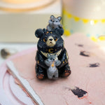 Moon Bear with wolves figurine