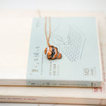 Nemo with a lace pendant