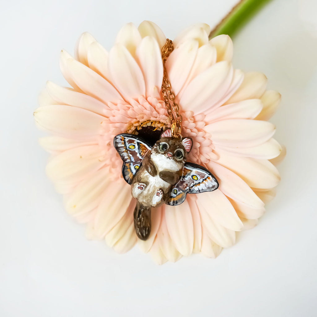 Norwegian forest cat with butterfly wings pendant