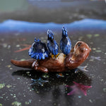 Clawless otter with black herons figurine