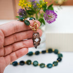 Otter with a mother-of-pearl pendant