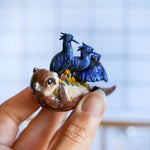 Clawless otter with black herons figurine